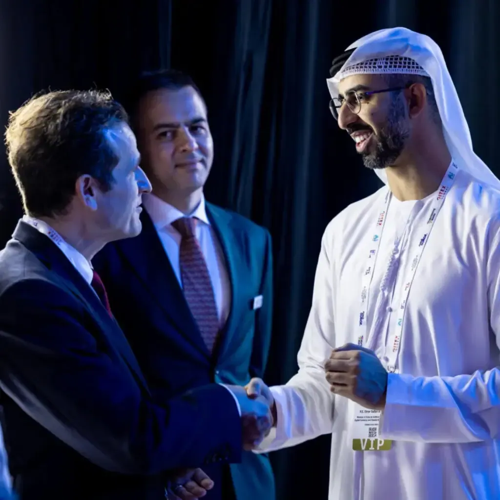 A delegate shaking hands with an Emirati official at a GITEX reception