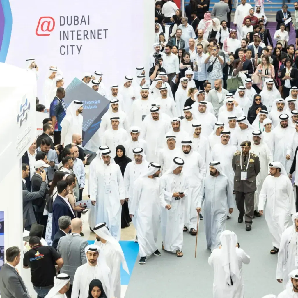 An Emirati delegation walking the show floor past the Dubai Internet City stand