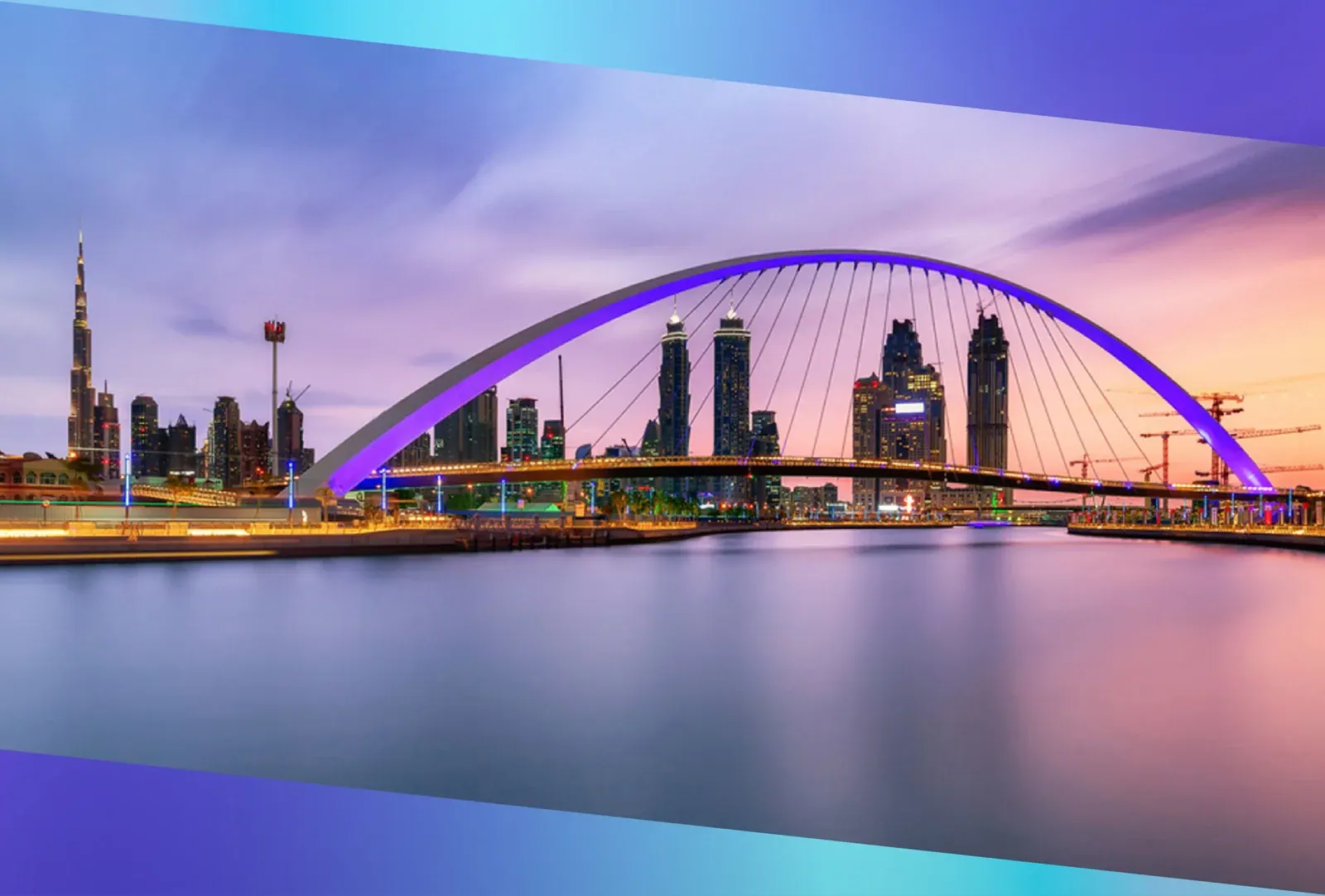 The Dubai Water Canal footbridge lit at dusk with the city skyline beyond