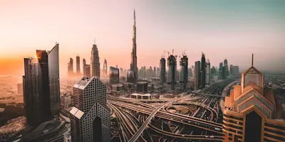 Downtown Dubai at sunrise, the Burj Khalifa rising above the Sheikh Zayed Road interchange