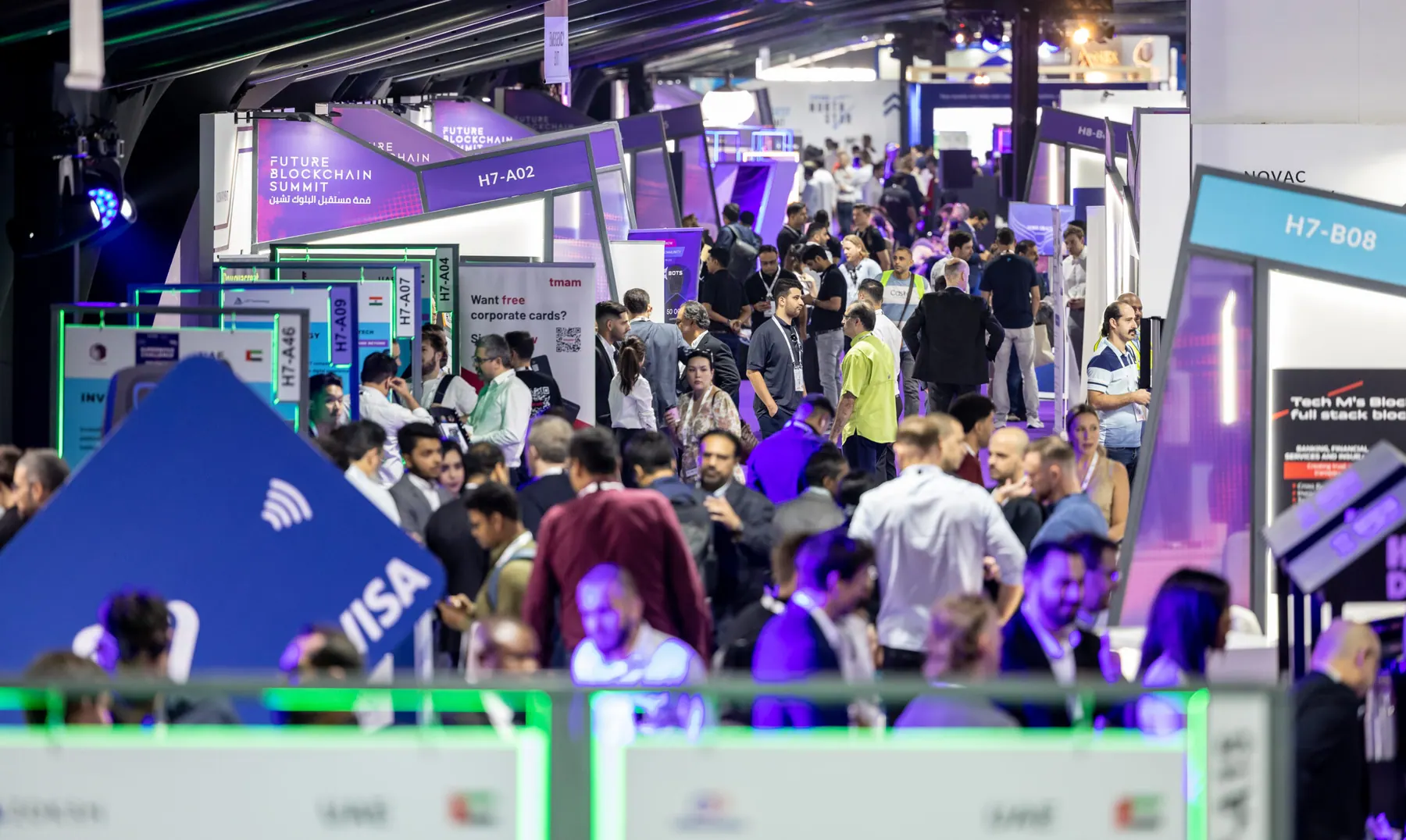 Visitors moving between exhibitor stands in a GITEX Global hall